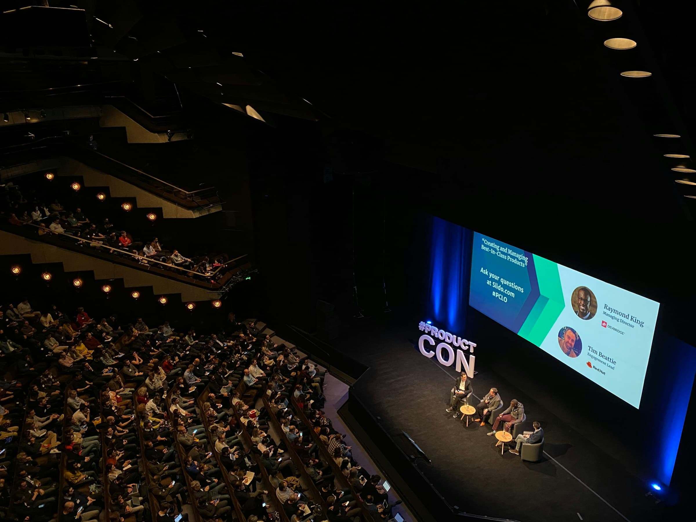 A large plenary hall filled with conference delegates